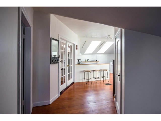 Bright kitchen with white countertops and hardwood floors. - Upper - 732 East 9th St, North Vancouver