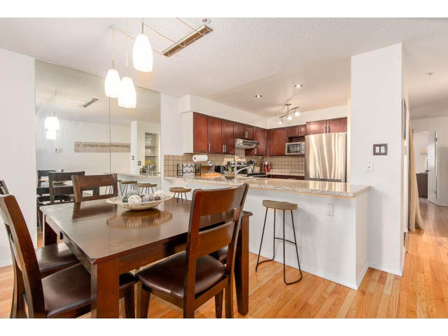 Bright kitchen with granite countertops, hardwood floors, and a modern dining area. - 101 - 2288 Laurel st., Vancouver West Side
