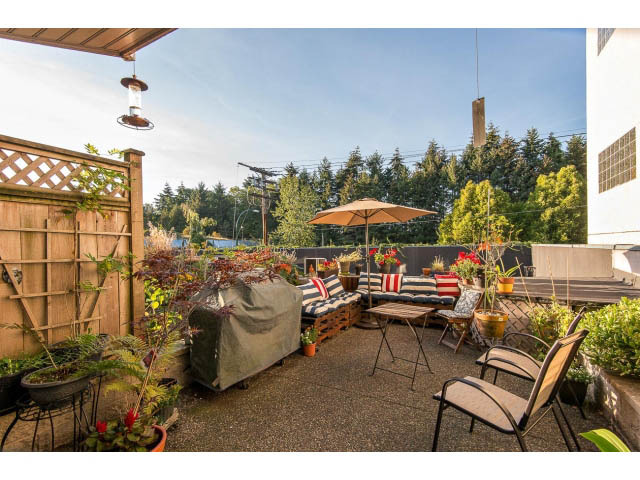 Furnished patio with outdoor furniture, plants, and a view of trees. - 101 - 2288 Laurel st., Vancouver West Side