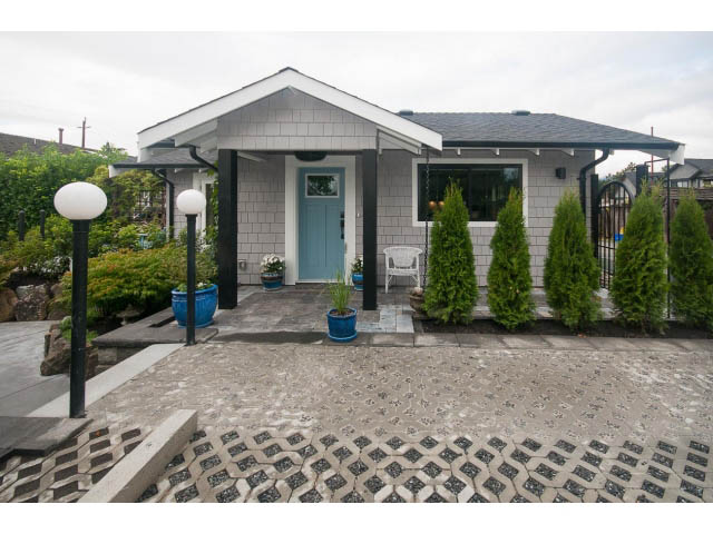 Furnished 1-bedroom house with a cozy front porch and modern landscaping. - 840-3 E 16th St., North Vancouver