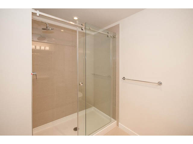 Bright bathroom with glass shower and modern fixtures. - 303 - 3825 Cate's Landing, North Vancouver