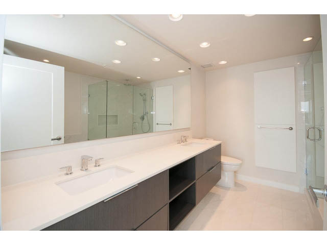 Bright bathroom with white countertops and modern fixtures. - 303 - 3825 Cate's Landing, North Vancouver