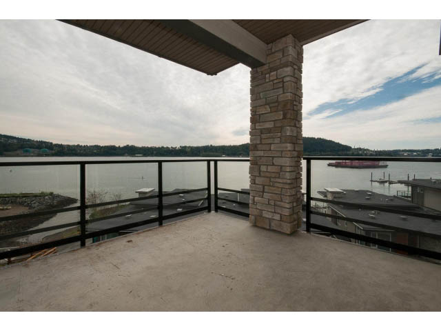 Spacious balcony with stone pillars and a view of the water. - 303 - 3825 Cate's Landing, North Vancouver