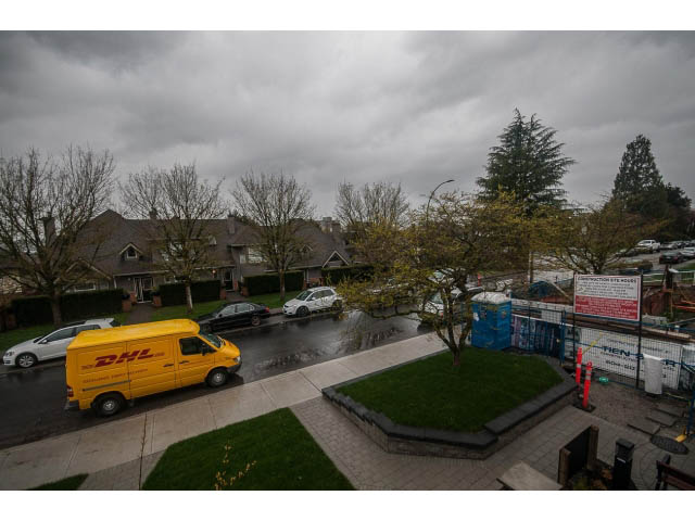 Furnished living room with city view and modern decor. - 5 - 244 5th E St, North Vancouver