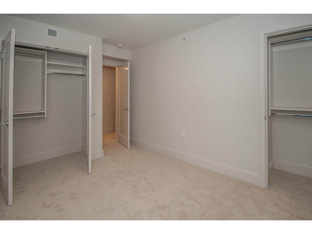 Spacious bedroom with large closet and built-in bench. - 5 - 244 5th E St, North Vancouver