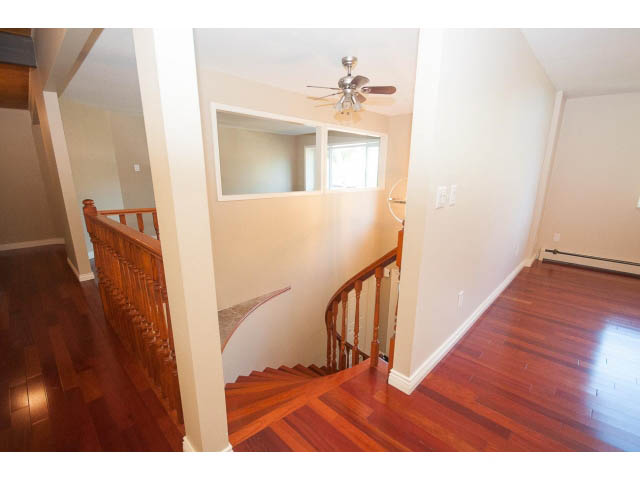 Bright entryway with hardwood floors and a staircase leading to upper levels. - 4135 Golf drive, North Vancouver