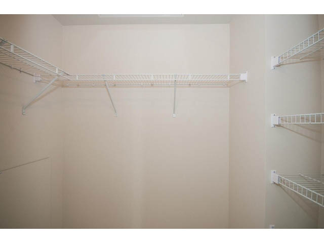 Empty walk-in closet with white wire shelving. - 414 - 255 West 1st St, North Vancouver