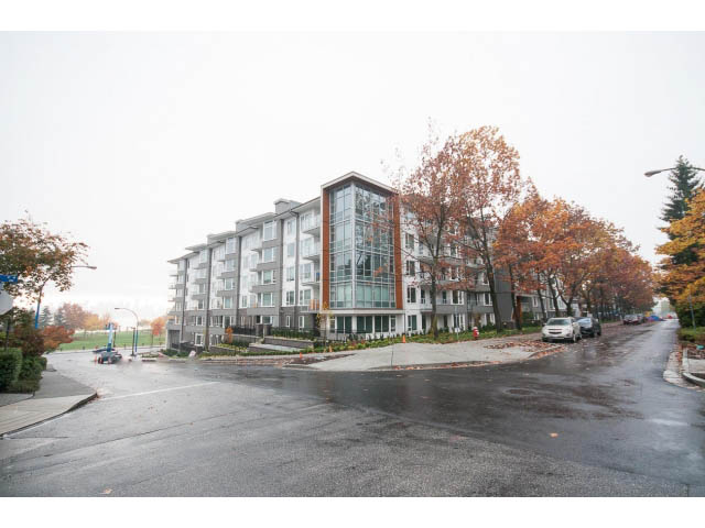 Furnished 3-bedroom condo with modern glass facade, surrounded by autumn foliage. - 414 - 255 West 1st St, North Vancouver