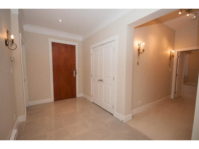 Spacious living room with marble floors and white walls, featuring a den area. - 708 - 4685 Valley Dr, Vancouver West Side
