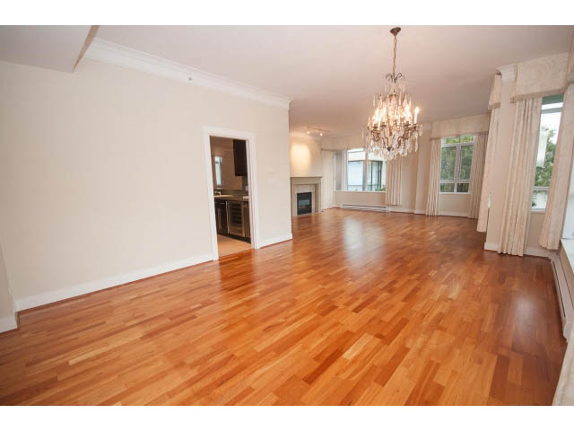 Spacious living room with hardwood floors and elegant chandelier. - 708 - 4685 Valley Dr, Vancouver West Side