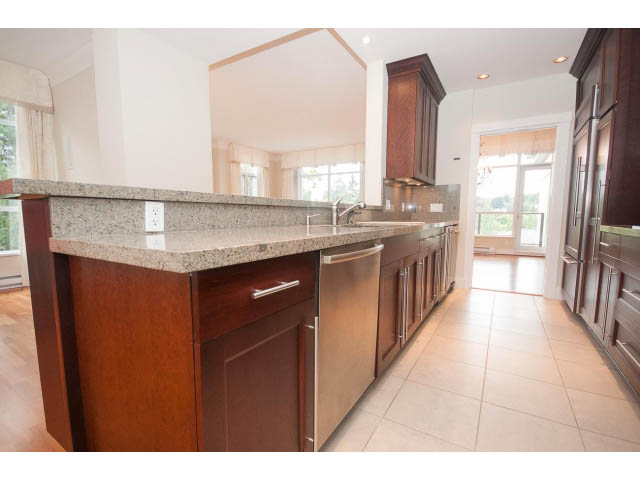 Bright kitchen with granite countertops, hardwood floors, and a city view. - 708 - 4685 Valley Dr, Vancouver West Side