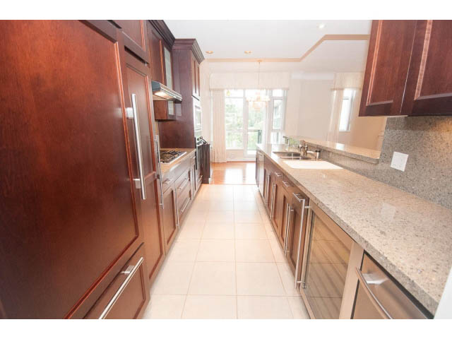 Bright kitchen with granite countertops, hardwood floors, and a city view. - 708 - 4685 Valley Dr, Vancouver West Side