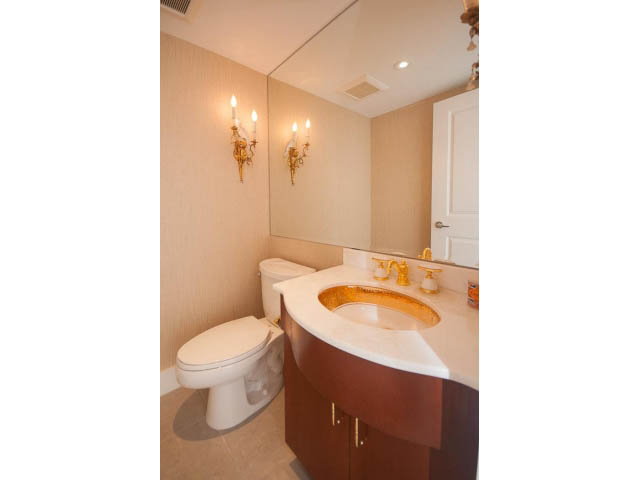 Furnished bathroom with a dual sink vanity, gold accents, and a toilet. - 708 - 4685 Valley Dr, Vancouver West Side