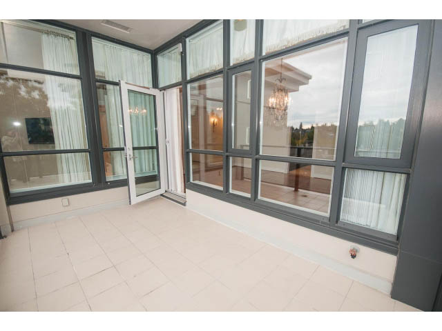 Bright sunroom with large windows, tiled floor, and view of trees outside. - 708 - 4685 Valley Dr, Vancouver West Side