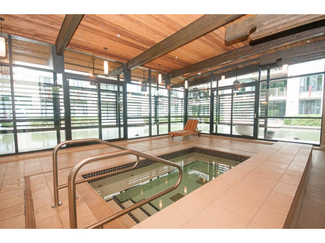 Spacious penthouse with large windows, wooden ceiling, and tiled pool area. - 708 - 4685 Valley Dr, Vancouver West Side
