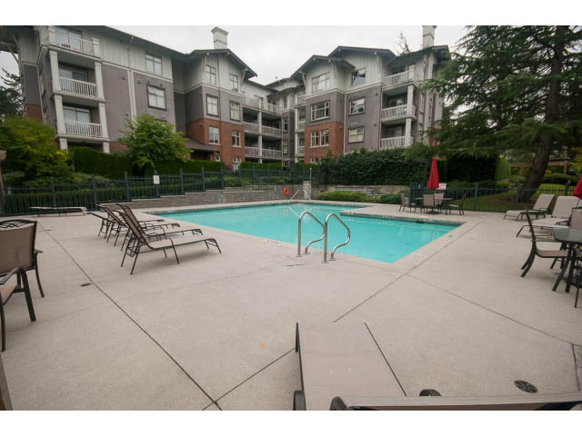 Spacious patio with outdoor furniture and swimming pool, surrounded by greenery. - 708 - 4685 Valley Dr, Vancouver West Side