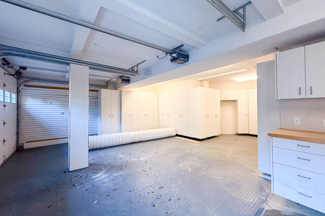 Double garage with tall storage cabinets along the back wall. - 3858 Sauve Place, North Vancouver