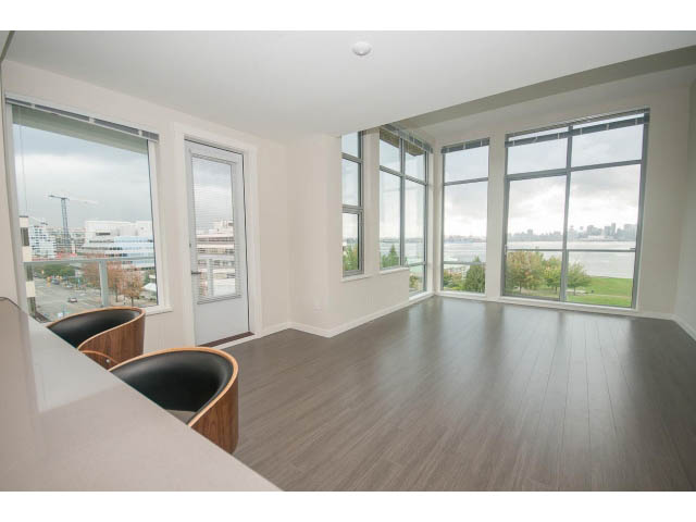 Bright living room with hardwood floors and city view. - 524 - 255 West 1st St, North Vancouver