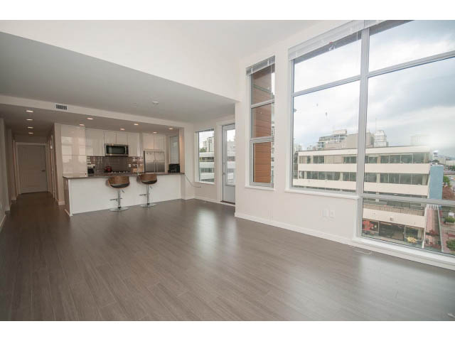 Spacious living room with hardwood floors, city view, and modern furnishings. - 524 - 255 West 1st St, North Vancouver