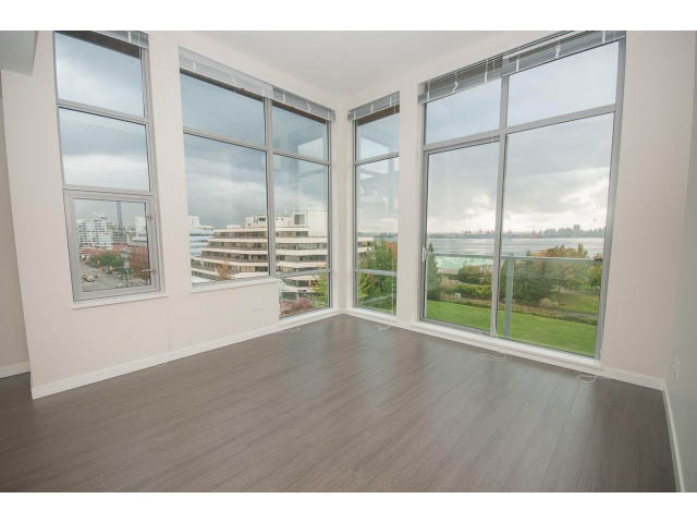 Bright living room with hardwood floors and a stunning city view. - 524 - 255 West 1st St, North Vancouver