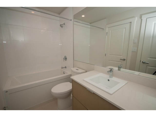 Bright bathroom with white countertops and a large mirror. - 524 - 255 West 1st St, North Vancouver