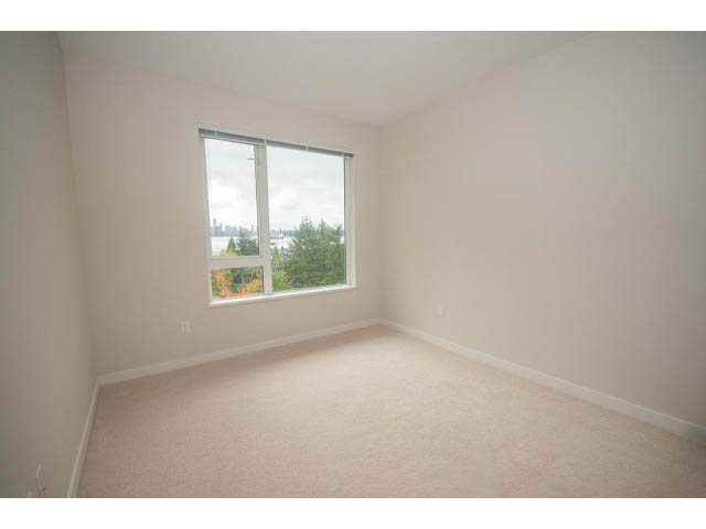 Bright living room with large windows offering a city view. - 524 - 255 West 1st St, North Vancouver