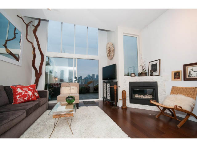 Furnished living room with hardwood floors, city view, and modern decor. - 1159 West 8th Avenue, Vancouver West Side