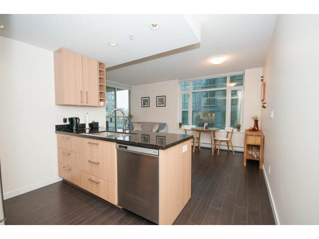Bright kitchen with modern cabinetry, hardwood floors, and a city view. - 802 - 1708 Columbia St, Vancouver West Side