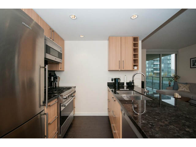 Bright kitchen with granite countertops, hardwood floors, and a city view. - 802 - 1708 Columbia St, Vancouver West Side