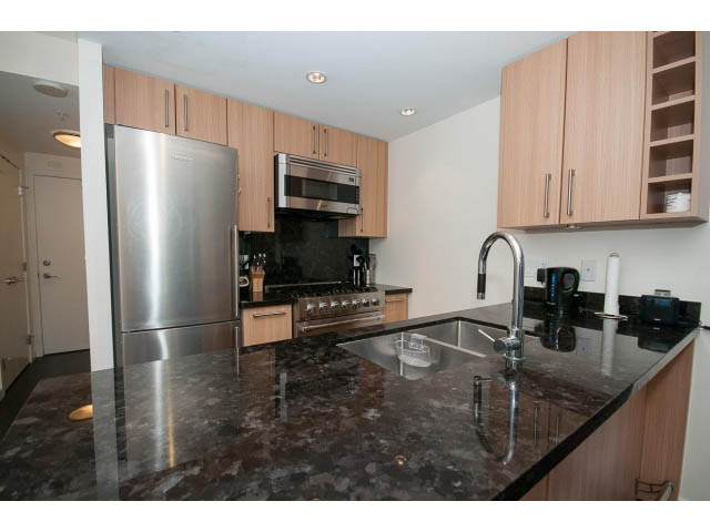 Bright kitchen with granite countertops and modern stainless steel appliances. - 802 - 1708 Columbia St, Vancouver West Side
