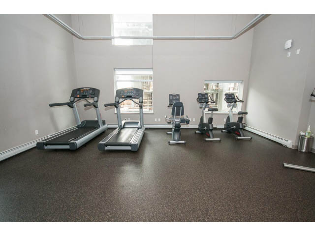Bright and spacious gym with treadmills, ellipticals, and cardio equipment. - 802 - 1708 Columbia St, Vancouver West Side