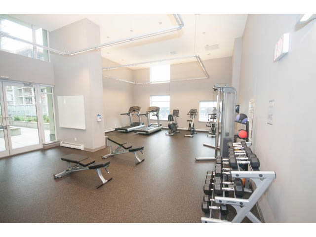 Spacious gym with cardio equipment and free weights. - 802 - 1708 Columbia St, Vancouver West Side