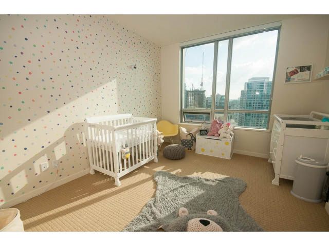 Bright nursery with colorful polka dot wallpaper, city view, and baby furniture. - 2401 - 1005 Beach Avenue, Vancouver Downtown