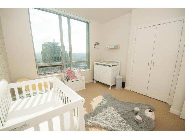 Bright and airy nursery with large windows, white crib, and city view. - 2401 - 1005 Beach Avenue, Vancouver Downtown