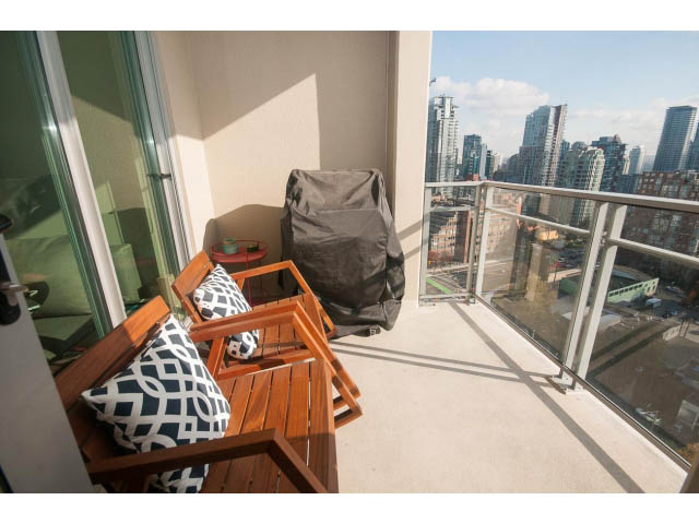 Furnished balcony with wooden furniture, city view, and outdoor seating. - 2401 - 1005 Beach Avenue, Vancouver Downtown
