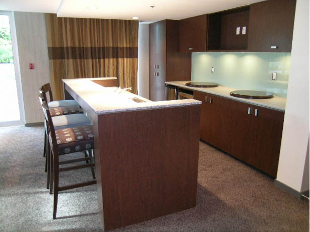 Bright kitchen with modern wood cabinets, white countertops, and a breakfast bar. - 2401 - 1005 Beach Avenue, Vancouver Downtown