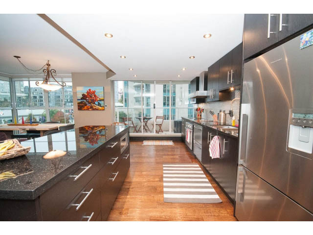 Bright kitchen with granite countertops, hardwood floors, and a city view. - 303 - 717 Jervis St, Vancouver Downtown