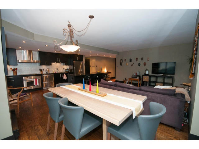Furnished dining area with wooden table, blue chairs, and modern decor. - 303 - 717 Jervis St, Vancouver Downtown