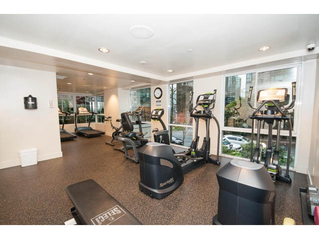 Bright and modern fitness room with cardio equipment and city view windows. - 303 - 717 Jervis St, Vancouver Downtown