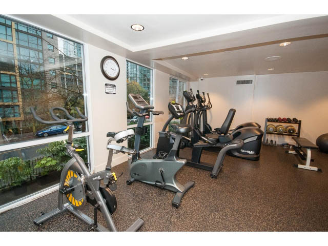 Bright and modern gym with exercise bikes and city view windows. - 303 - 717 Jervis St, Vancouver Downtown