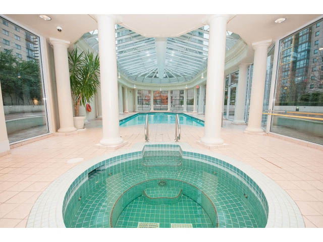 Spacious living room with large windows, green tiled pool area, and modern decor. - 303 - 717 Jervis St, Vancouver Downtown