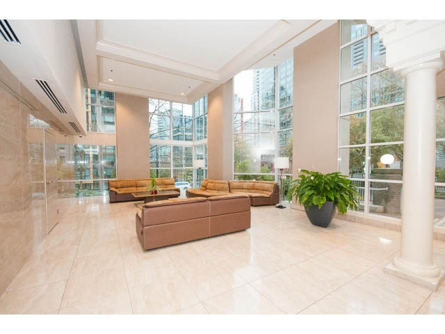 Furnished living room with large windows, city view, and marble floors. - 303 - 717 Jervis St, Vancouver Downtown