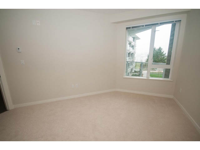 Spacious living room with large windows and city view. - 330 - 255 West 1st St, North Vancouver