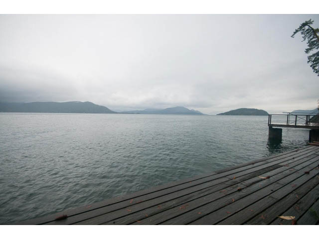 Furnished deck overlooking serene water and distant mountains. - 8135 Pasco Rd, West Vancouver
