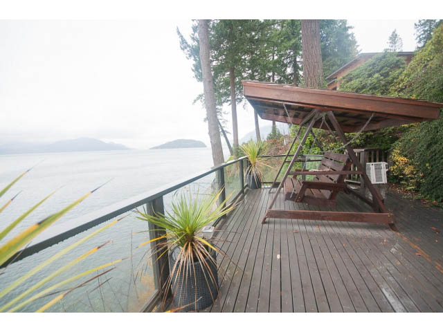 Furnished deck with ocean view and wooden flooring. - 8135 Pasco Rd, West Vancouver