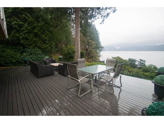 Furnished patio with outdoor furniture and a view of the water. - 8135 Pasco Rd, West Vancouver