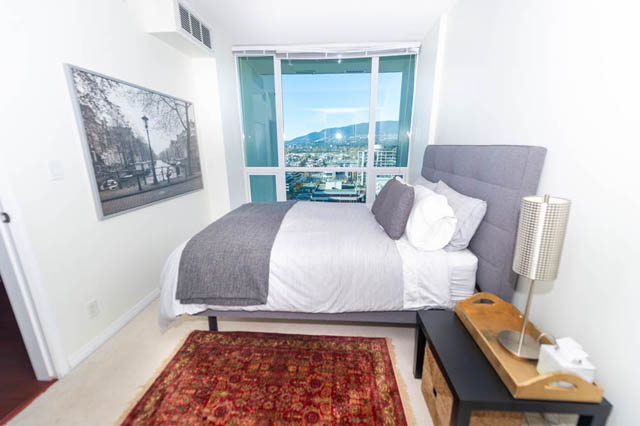 Bright bedroom with city view and modern furnishings. - 1905 - 138 East Esplanade Ave, North Vancouver