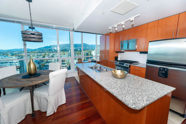 Bright kitchen with granite countertops, hardwood floors, and a city view. - 1905 - 138 East Esplanade Ave, North Vancouver
