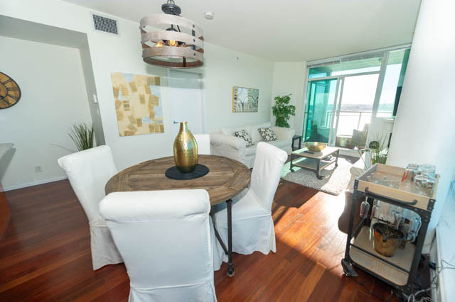Furnished living room with hardwood floors, city view, and modern decor. - 1905 - 138 East Esplanade Ave, North Vancouver