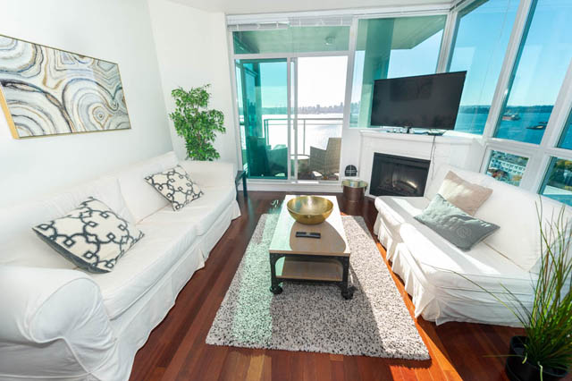 Spacious living room with city view, hardwood floors, and modern decor. - 1905 - 138 East Esplanade Ave, North Vancouver